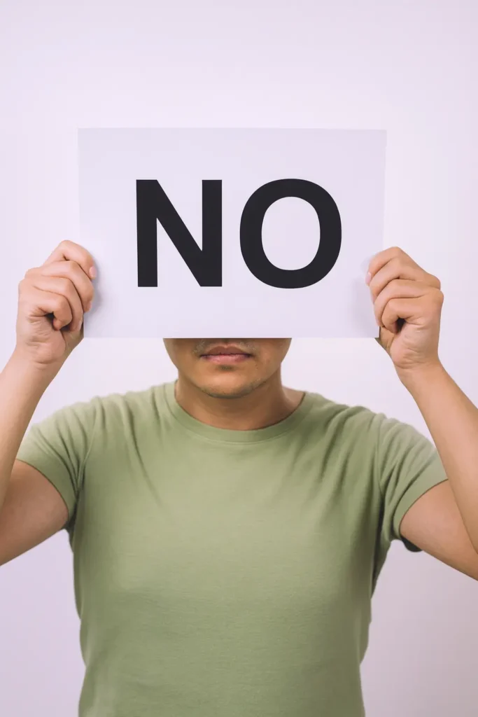 Person holding a sign that says “NO,” symbolizing that not every toothache requires tooth extraction.